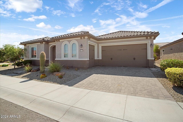 mediterranean / spanish-style house with a garage