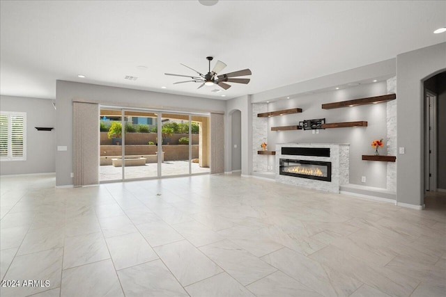 unfurnished living room with light tile patterned floors and ceiling fan