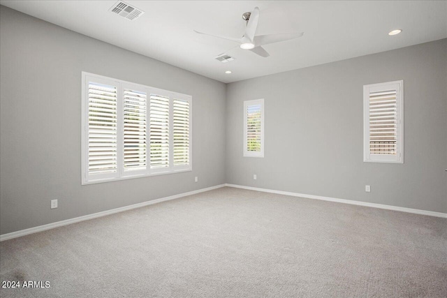 spare room with ceiling fan and carpet floors