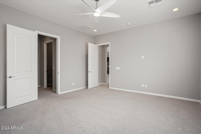 unfurnished bedroom with light colored carpet and ceiling fan