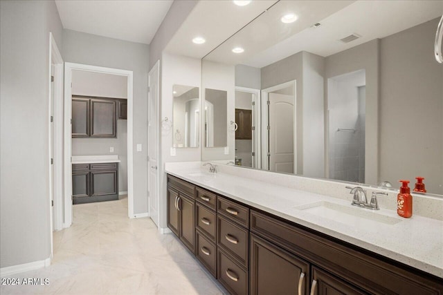 bathroom with tile patterned flooring and vanity