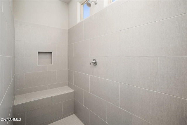 bathroom with a tile shower