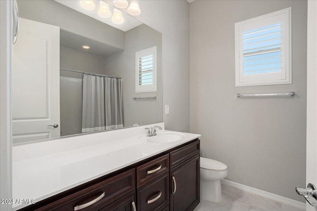 bathroom featuring tile patterned floors, toilet, vanity, and a shower with curtain