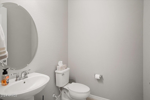 bathroom featuring sink and toilet