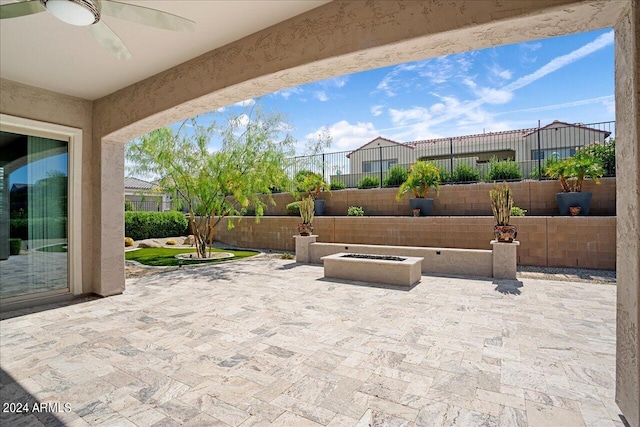 view of patio / terrace featuring ceiling fan and an outdoor fire pit