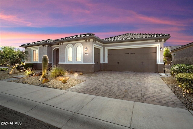 mediterranean / spanish house featuring a garage