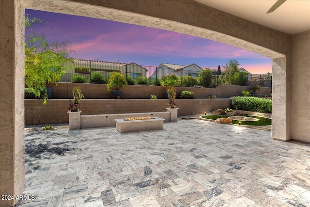 patio terrace at dusk with a fire pit