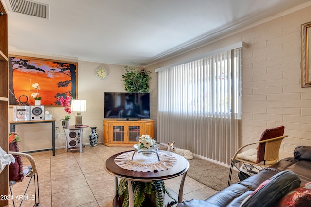 living room with tile floors and crown molding