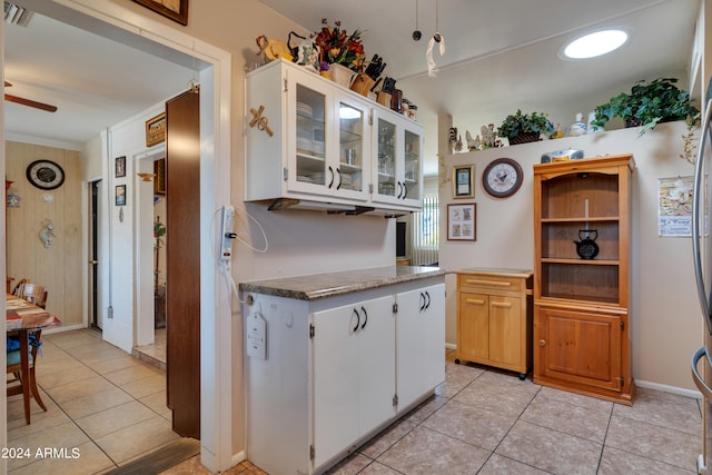 kitchen with white cabinetry, ceiling fan, and light tile floors