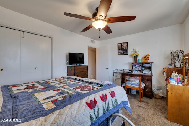 bedroom featuring ceiling fan, a closet, and carpet flooring