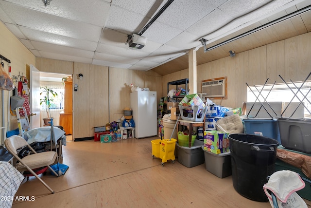 garage featuring a garage door opener and white fridge