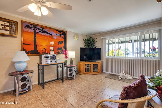 living room with tile floors, crown molding, and ceiling fan