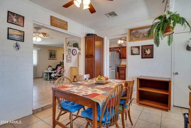 dining space featuring ceiling fan and light tile floors