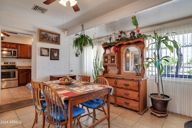 tiled dining area with ceiling fan