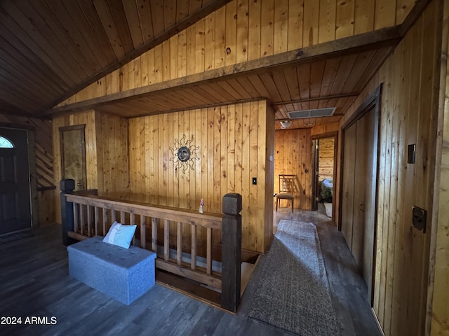 hallway featuring wooden walls, lofted ceiling, dark hardwood / wood-style floors, and wooden ceiling