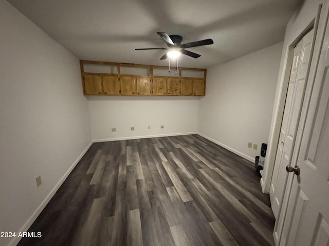 unfurnished bedroom featuring ceiling fan and dark hardwood / wood-style floors