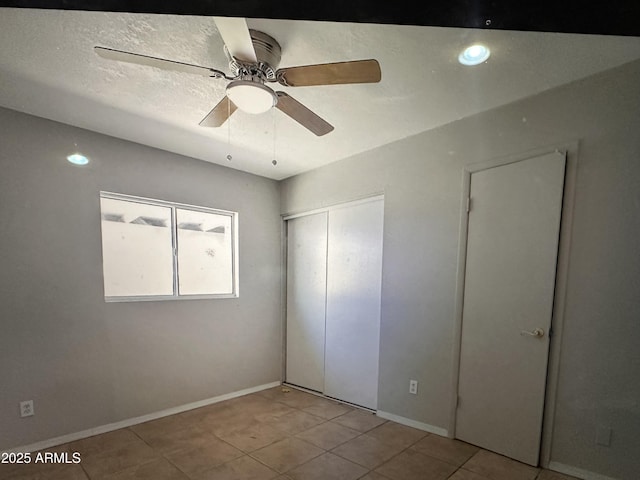 6111 N 64th Dr, Glendale, AZ 85301 - unfurnished bedroom with tile patterned floors, a closet, ceiling fan, and baseboards