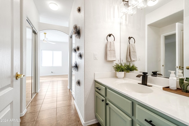 bathroom with tile patterned flooring, vanity, and ceiling fan