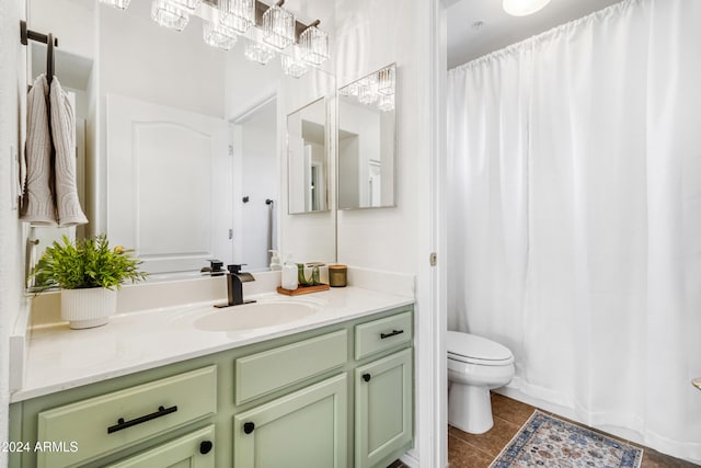 bathroom with tile patterned flooring, vanity, and toilet