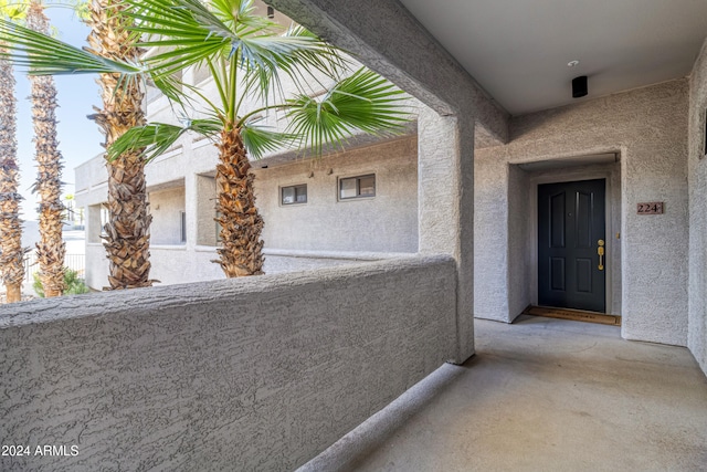 view of exterior entry with a balcony