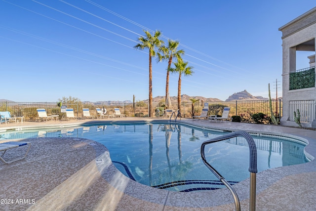 view of pool with a mountain view and a patio