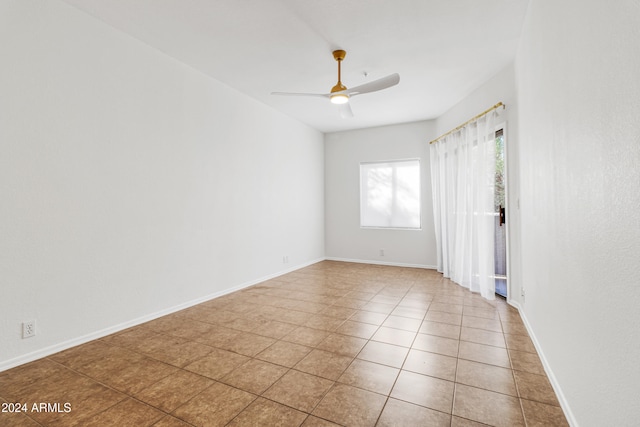 tiled empty room with ceiling fan