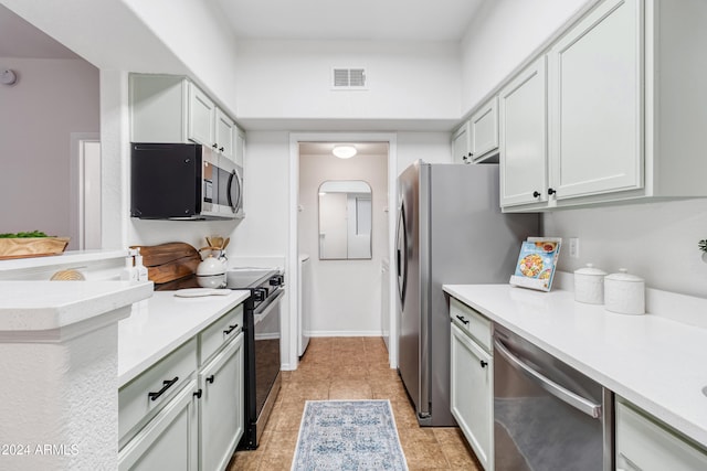 kitchen featuring light tile patterned floors and stainless steel appliances