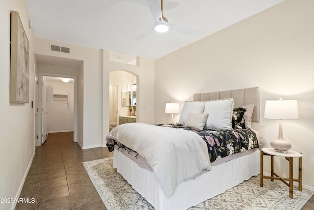 10401 N Saguaro Blvd Unit 224, Fountain Hills, AZ 85268 - bedroom with arched walkways, baseboards, ensuite bath, tile patterned floors, and ceiling fan