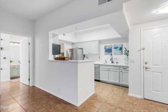 kitchen with sink, light tile patterned floors, and stainless steel appliances