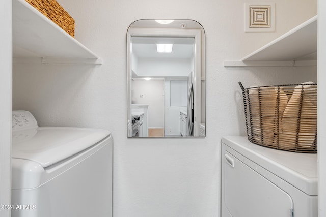 laundry room with separate washer and dryer