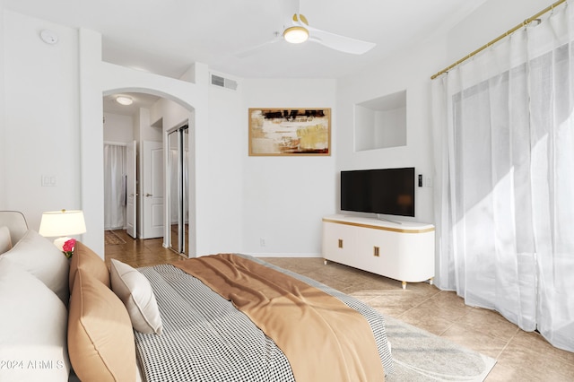 tiled bedroom with ceiling fan