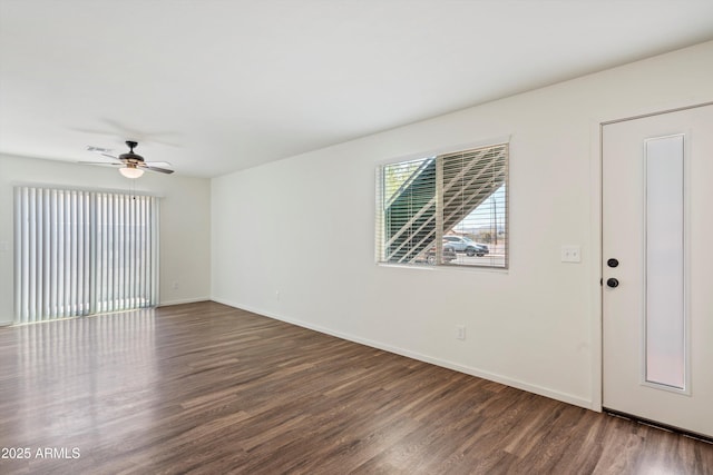 spare room featuring dark wood-type flooring and ceiling fan