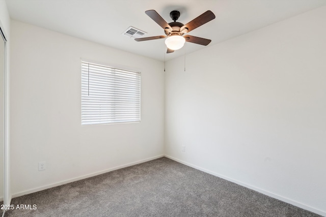 carpeted spare room with ceiling fan