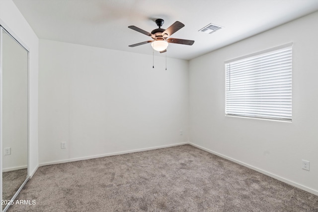 unfurnished room with light colored carpet and ceiling fan