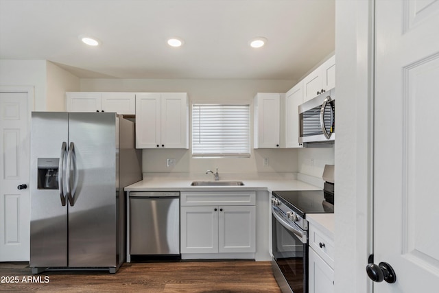 kitchen with sink, white cabinets, dark hardwood / wood-style flooring, and appliances with stainless steel finishes