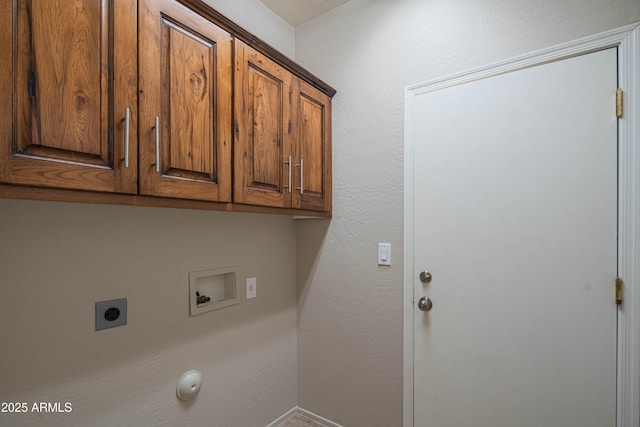 clothes washing area with hookup for a washing machine, cabinet space, and electric dryer hookup