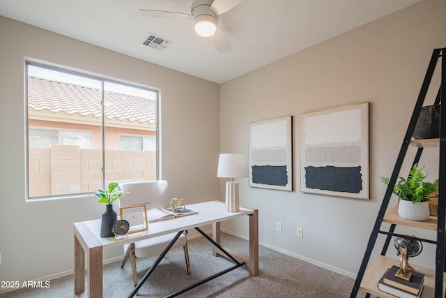 carpeted office space with ceiling fan, visible vents, and baseboards