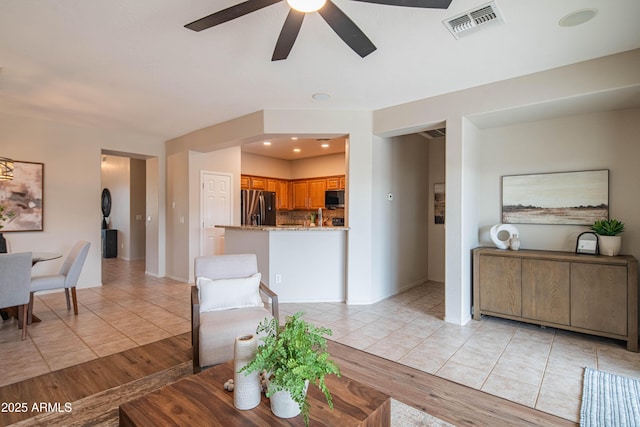 living room featuring light tile patterned floors, recessed lighting, visible vents, baseboards, and a ceiling fan