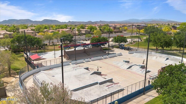 view of community featuring fence and a mountain view