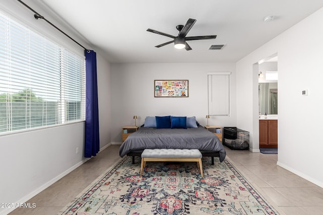 7910 S 33rd Ln, Laveen, AZ 85339 - bedroom with light tile patterned floors, ensuite bath, and ceiling fan