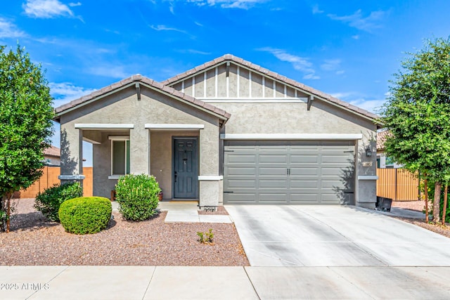 7910 S 33rd Ln, Laveen, AZ 85339 - view of front facade with a garage, stucco siding, driveway, and a tile roof