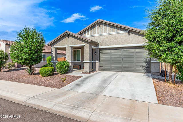 7910 S 33rd Ln, Laveen, AZ 85339 - view of front of property with stucco siding, an attached garage, driveway, a tiled roof, and covered porch