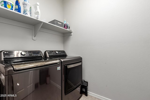 7910 S 33rd Ln, Laveen, AZ 85339 - laundry area featuring washer and clothes dryer and light tile patterned floors