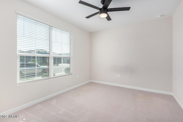 unfurnished room featuring ceiling fan and carpet