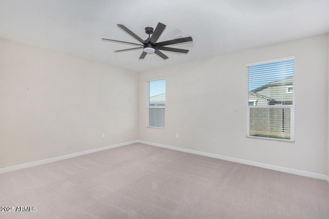 unfurnished room featuring ceiling fan and light carpet