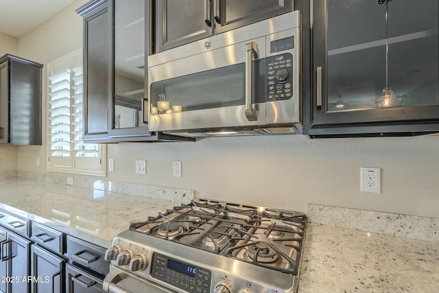 kitchen featuring light stone counters and stainless steel appliances