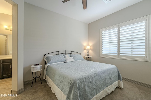 bedroom featuring ceiling fan, carpet floors, and ensuite bath