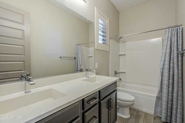 full bathroom with shower / tub combo with curtain, wood-type flooring, toilet, and vanity