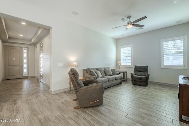 living room with ceiling fan and light wood-type flooring