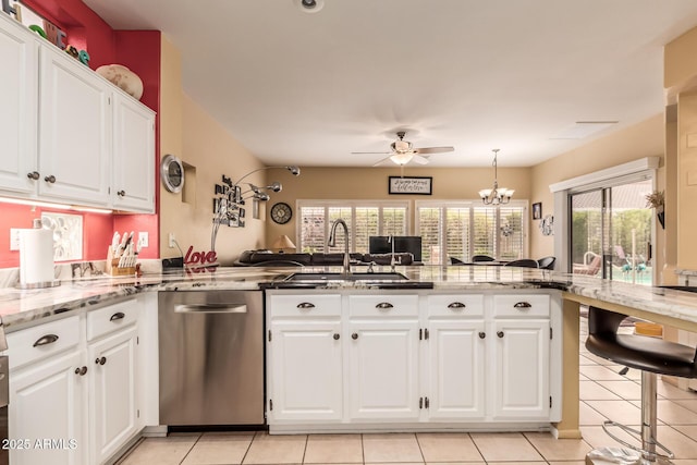 kitchen featuring dishwasher, white cabinetry, light stone counters, ceiling fan with notable chandelier, and kitchen peninsula